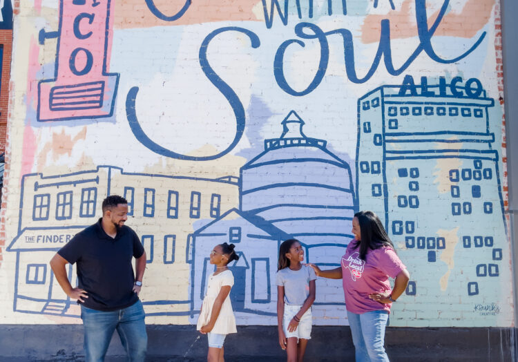 Parents with two young daughters standing in front of 